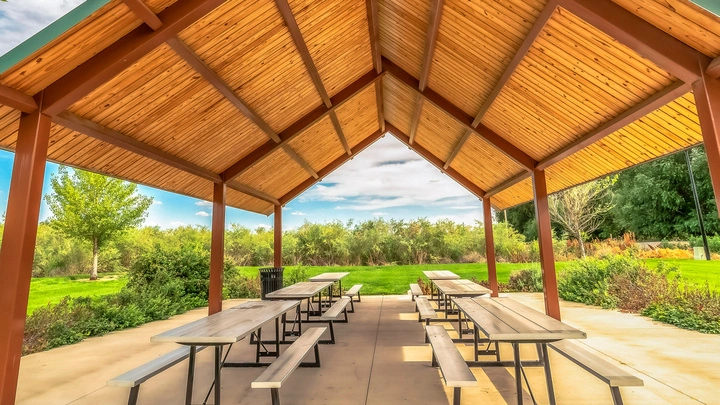 Spacious outdoor pavilions featuring picnic tables, ideal for summer gatherings, by Hawkins Landscaping.