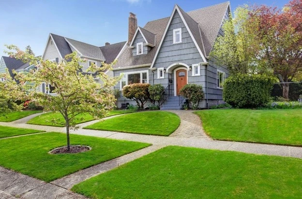 Beautiful home with lush green lawn and tidy pathways showcasing stunning landscaping ideas for front yard this autumn.